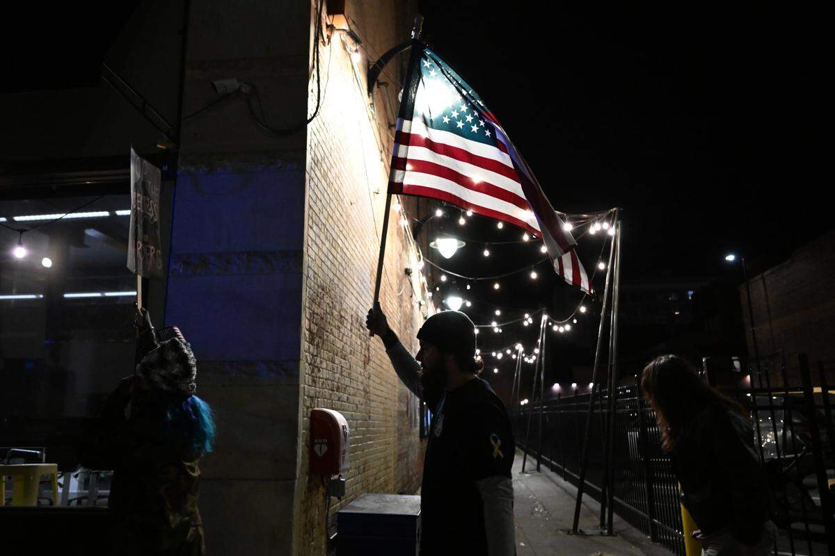 Matt Tigner, from Warner Robins, Georgia, carries an American flag during the March on Macon on Wednesday, Jan. 28, 2026, in downtown Macon, Georgia. 