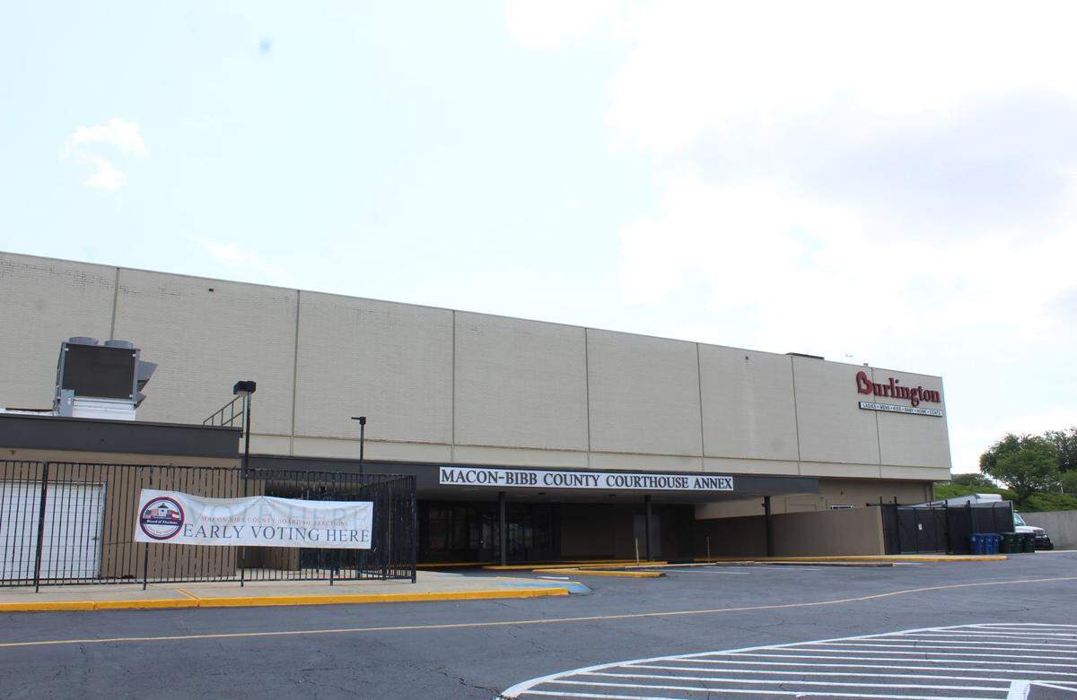 A 3-by-8 foot sign that reads, “Early voting here,” is posted between the Macon-Bibb County Board of Elections office and the county courthouse annex at Macon Mall.