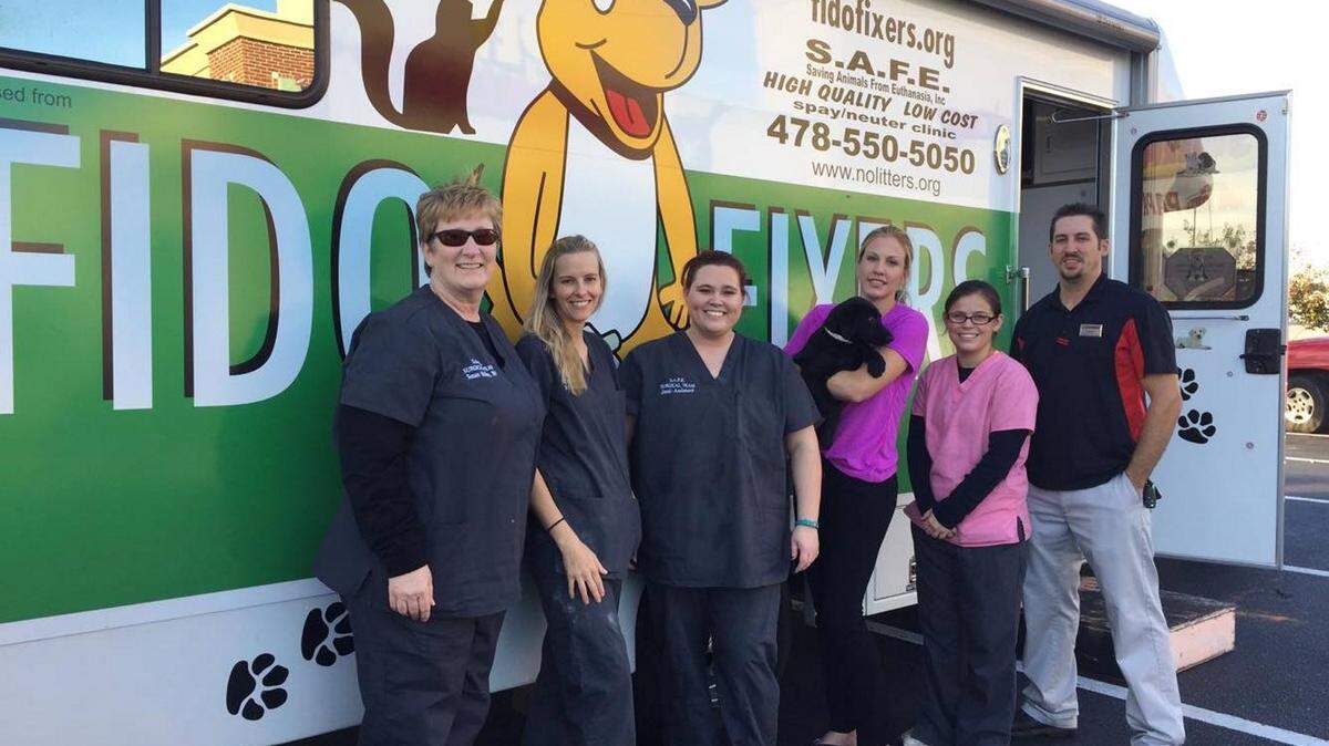 Susan Helton, left, is the president of S.A.F.E., or Saving Animals From Euthanasia. In November, her organization spayed or neutered its 10,000th animal in Macon. Helton is shown here with members of her organization.