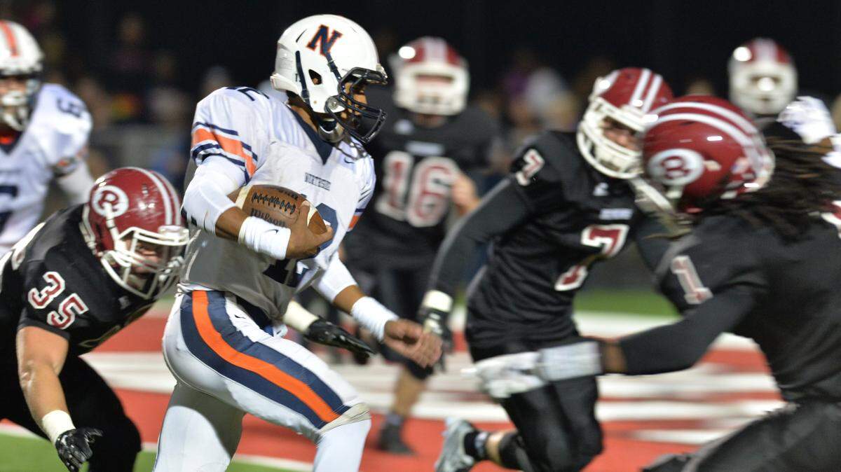 Northside quarterback Tobias Oliver splits the middle between Warner Robins defenders as he runs for the third Northside touchdown of the first half last Friday.
