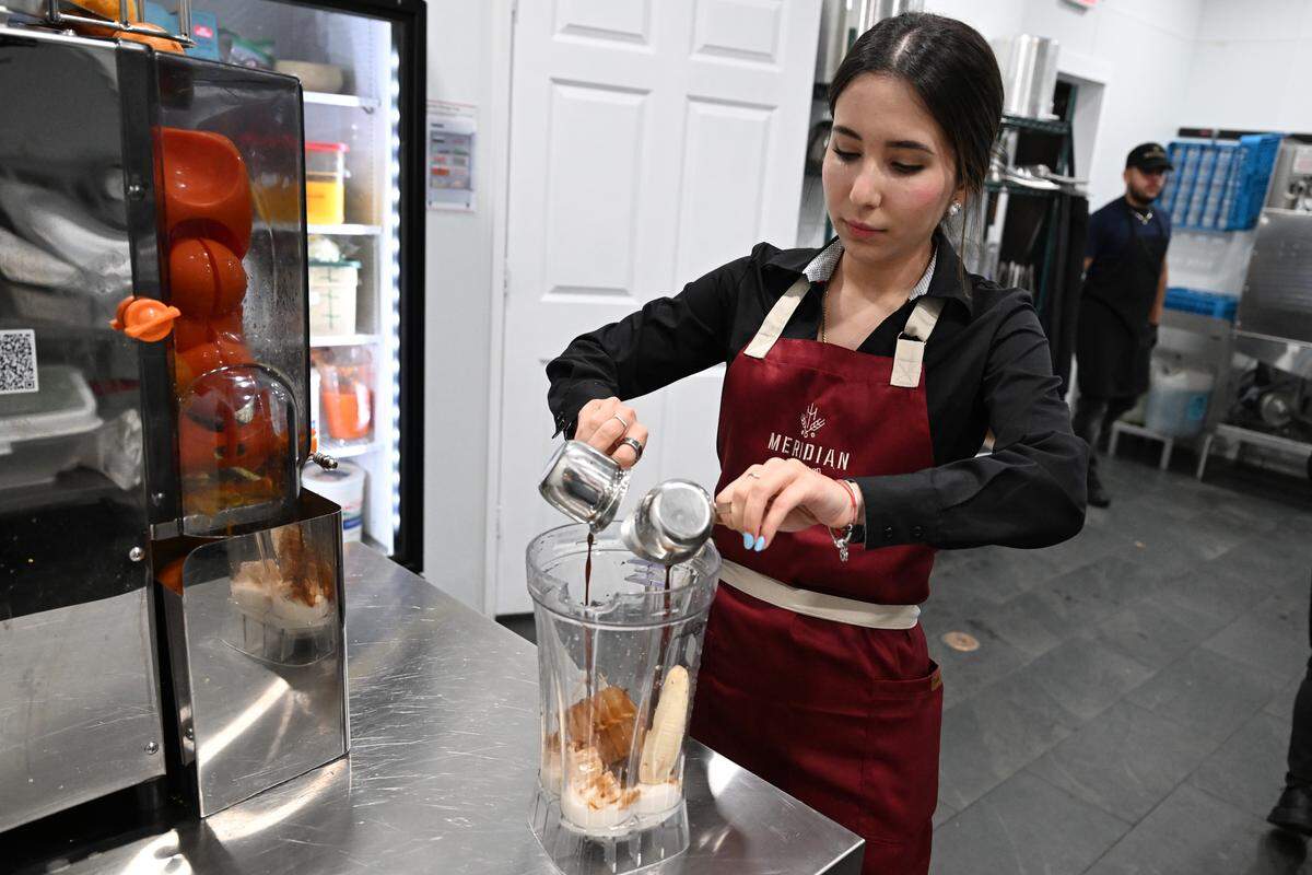 Meridian Brunch & Bar co-owner Gissele Aguilar adds espresso to the Meridian smoothie at the brunch restaurant in Perry.