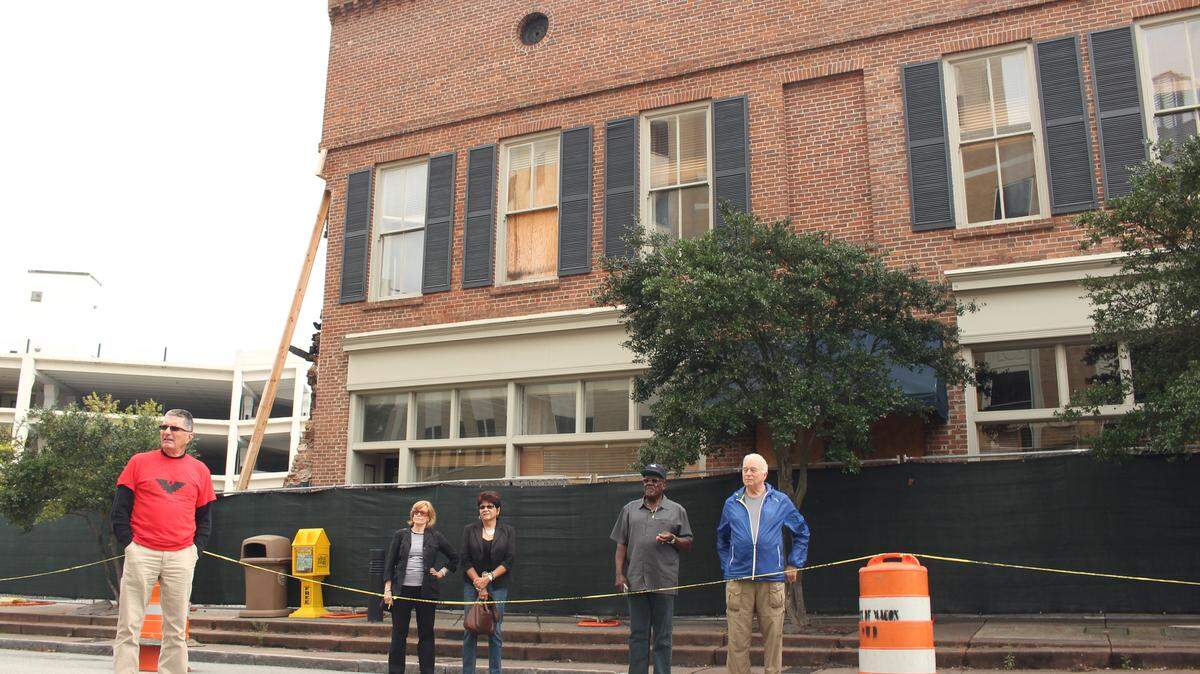 Some of the group members stand in front of their old headquarters on Cotton Avenue, Oct. 4, 2015.