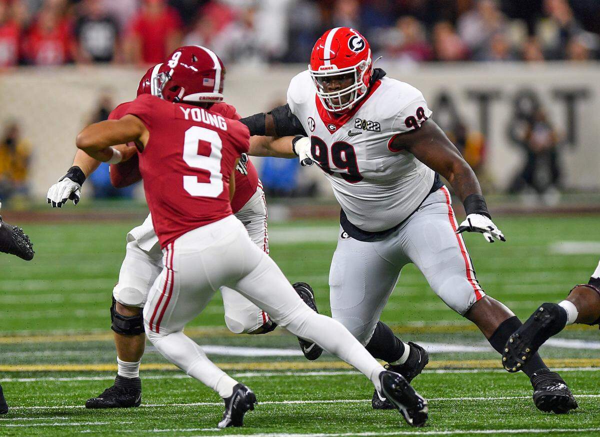 Georgia defensive lineman Jordan Davis (99) chases down Alabama quarterback Bryce Young (9) during the College Football Playoff National Championship game Monday night.
