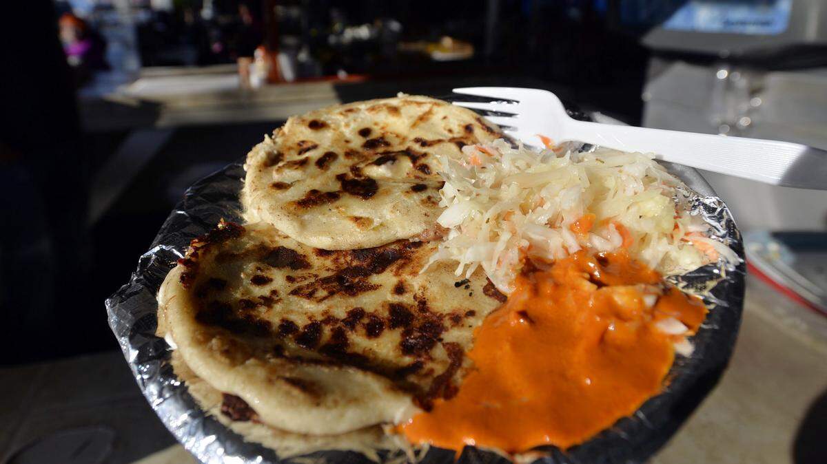 BEAU CABELL/THE TELEGRAPHEl Salvadoran papusas are served with cabbage and a liberal squirt of hot sauce at Las Delicias, one of the Mexican food stalls at Smiley's Flea Market.