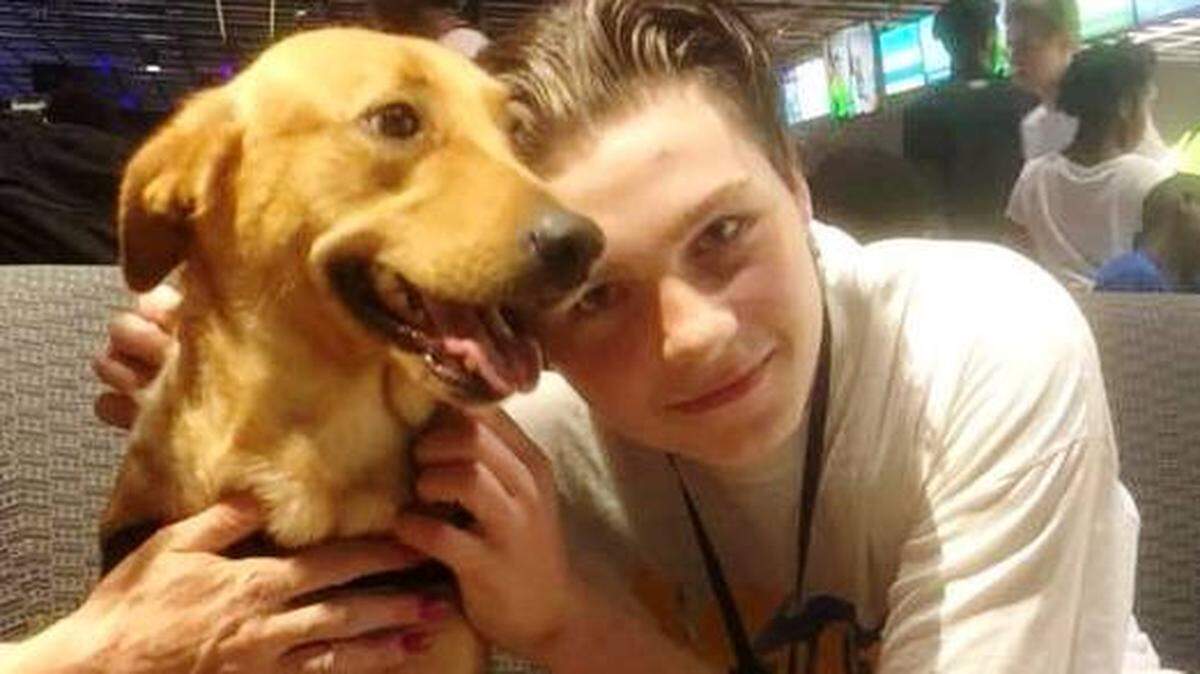 David Ray, 15, with his dog, Mallory, at a Macon bowling alley last weekend. His parents,  Suzeanna and Matthew Brill, were separated from him when they were arrested for reckless conduct for allowing him to smoke marijuana to stop epileptic seizures. They hope to win a court hearing Monday for David to come home.