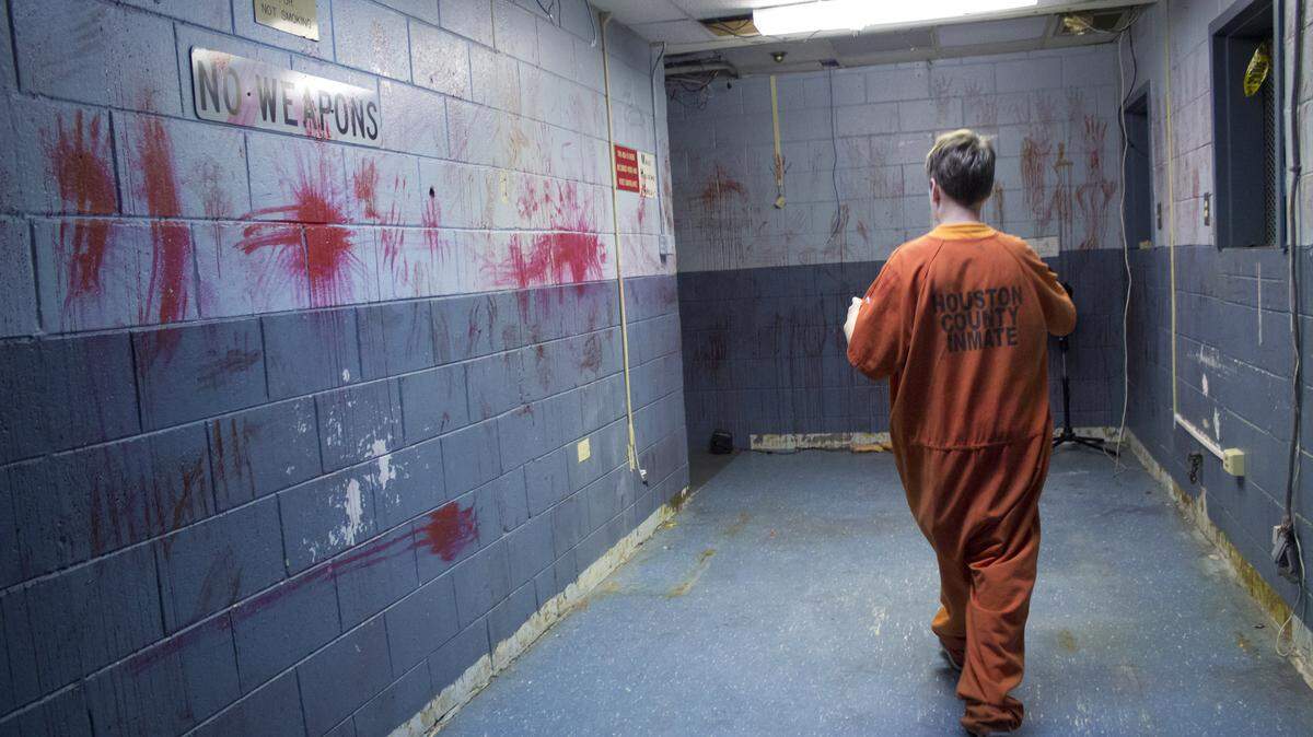 "Inmate" Logan Coleman tours the jail at the Warner Robins Police Department's Haunted House during the setup time before customers arrive for a scare. Coleman said the actors in each of the Haunted House's scenes come up with their scripts together, and they sometimes improvise to mix things up.