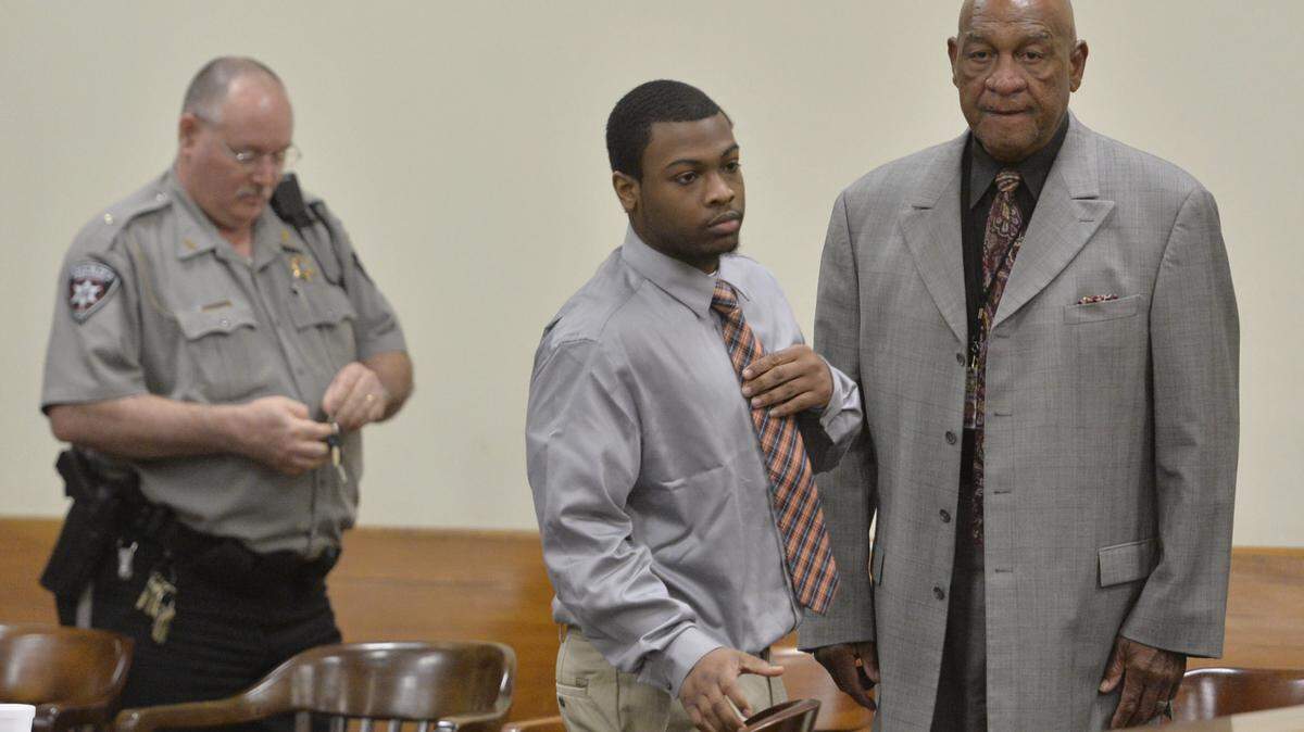 Bailiffs escort Jedarrius Meadows, center, back to Judge Howard Simms' courtroom during a break in his trial Wednesday.