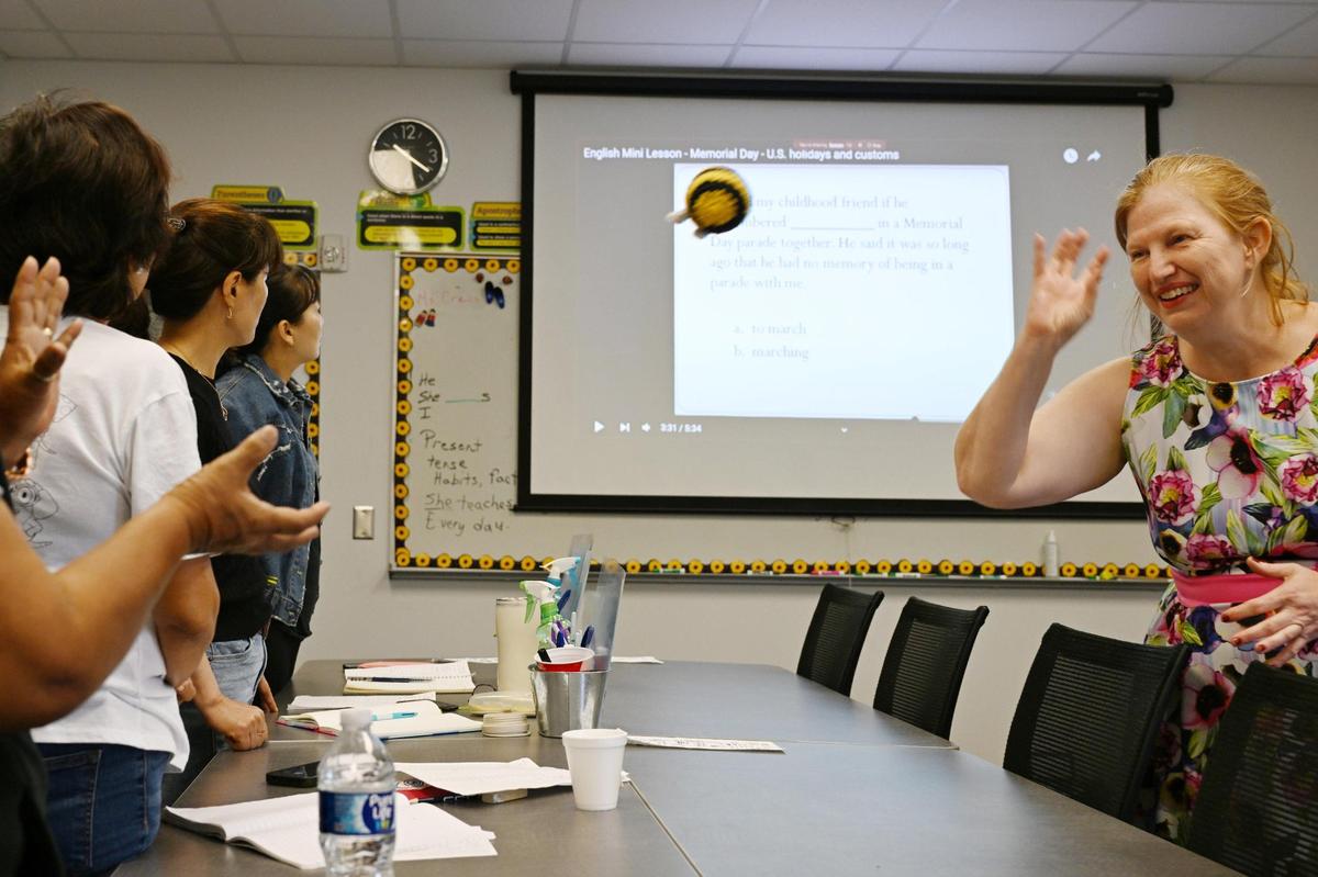 Adult education instructor Mary Crews (right) throws a plush bee to a student as her students answer questions in an English as a Second Language (ESL) class on Tuesday, May 27, 2025, at Central Georgia Technical College in Warner Robins, Georgia. President Trump’s proposed budget includes a $729 million reduction to adult education services, including the Adult Education and Family Literacy Act which supports adult learners 16 and older.
