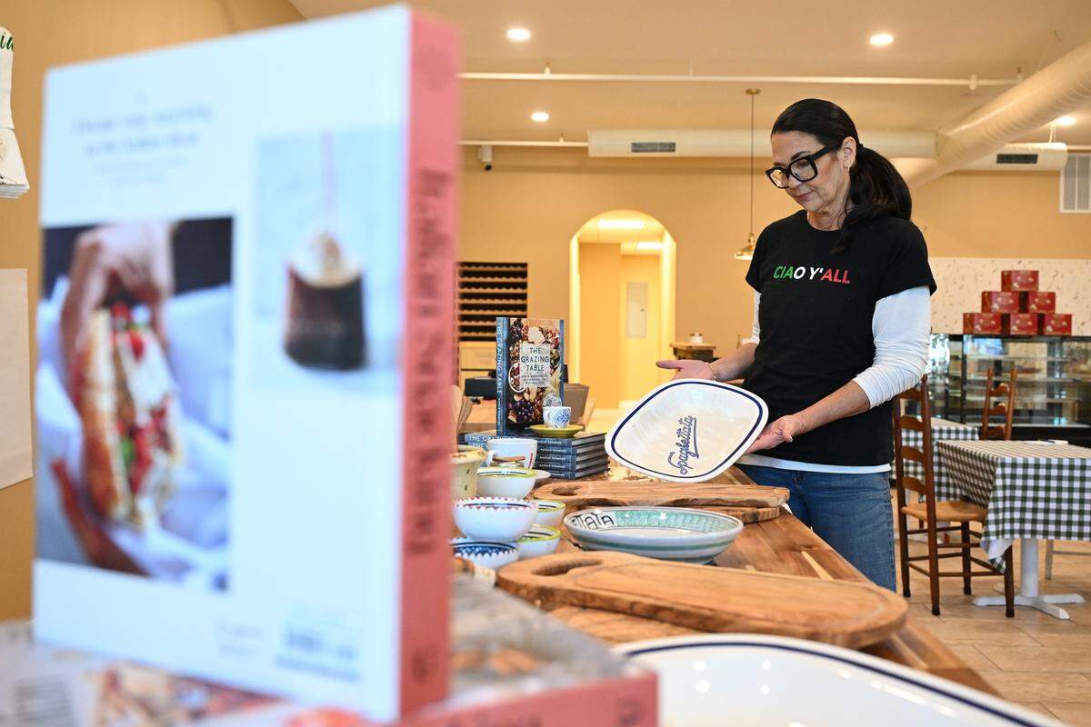 Ciao Bella Market owner Telisa Asaro shows a ceramic serving platter with “Spaghettae” written across the middle that is for sale at Ciao Bella Market in Perry. Asaro said she found the dishes at a flea market.