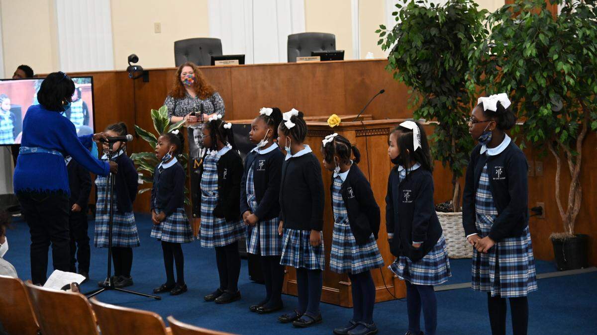 M.A. Evans Academy students recite a portion of Martin Luther King Jr.’s “I Have a Dream” speech during a ceremony at in the Macon-Bibb County Commission chamber Monday morning.