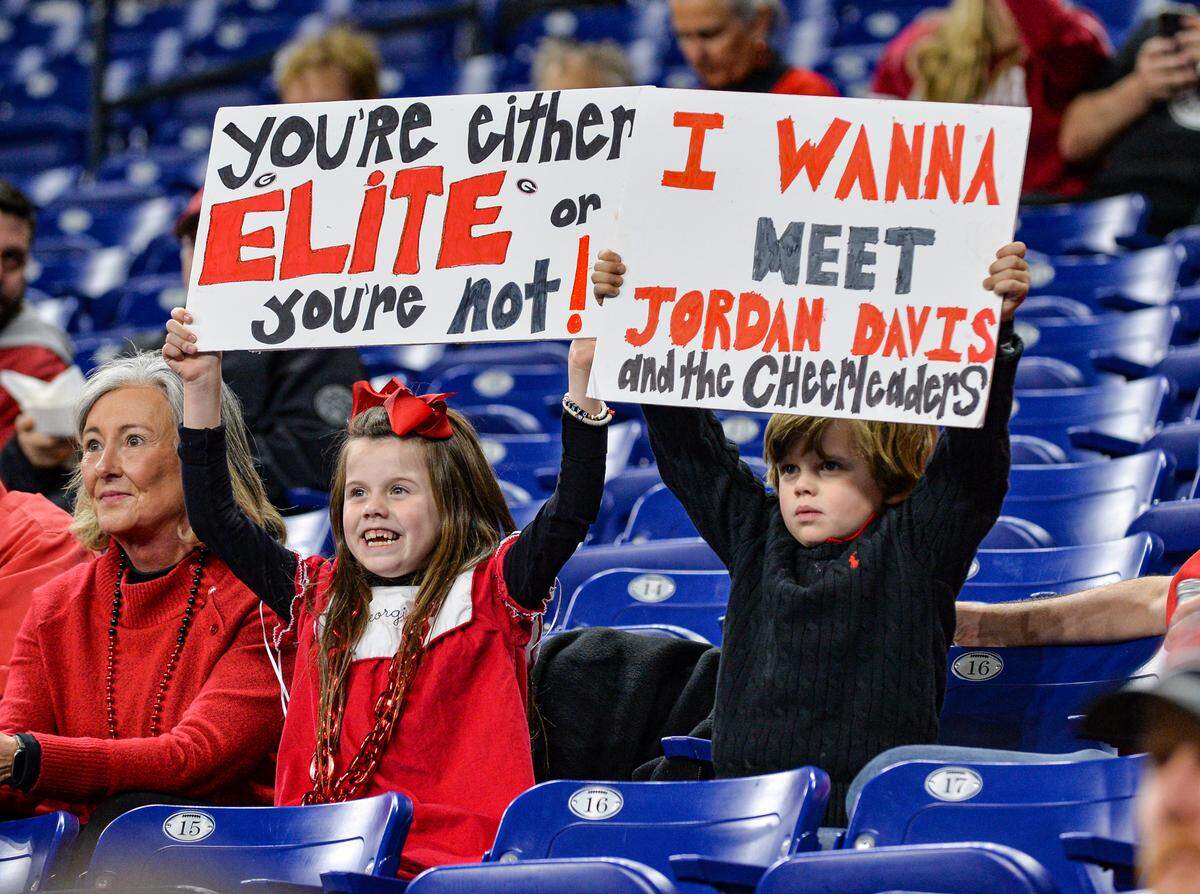 Young Georgia fans cheer on the Bulldogs prior to their College Football Playoff National Championship game against Alabama Monday night.