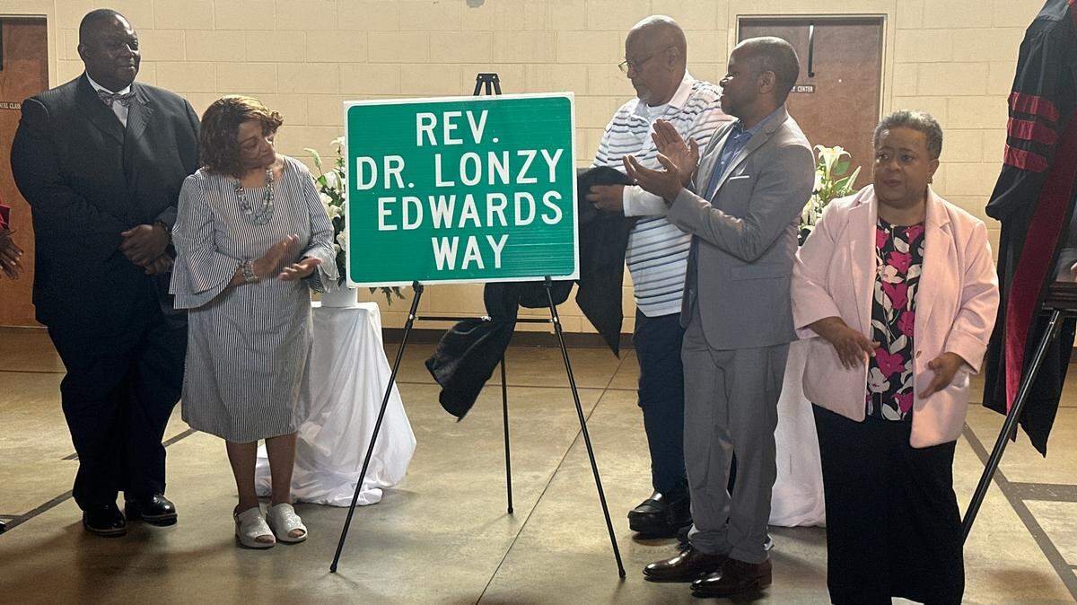 Family and friends of Lonzy Edwards, a former Bibb County Commissioner, gathered at Mt. Moriah Baptist Missionary Church to unveil street signs in his honor on Tuesday, April 29, 2025. A portion of Millerfield Road is now known as Dr. Lonzy Edwards Way. (Photo/Lucinda Warnke)