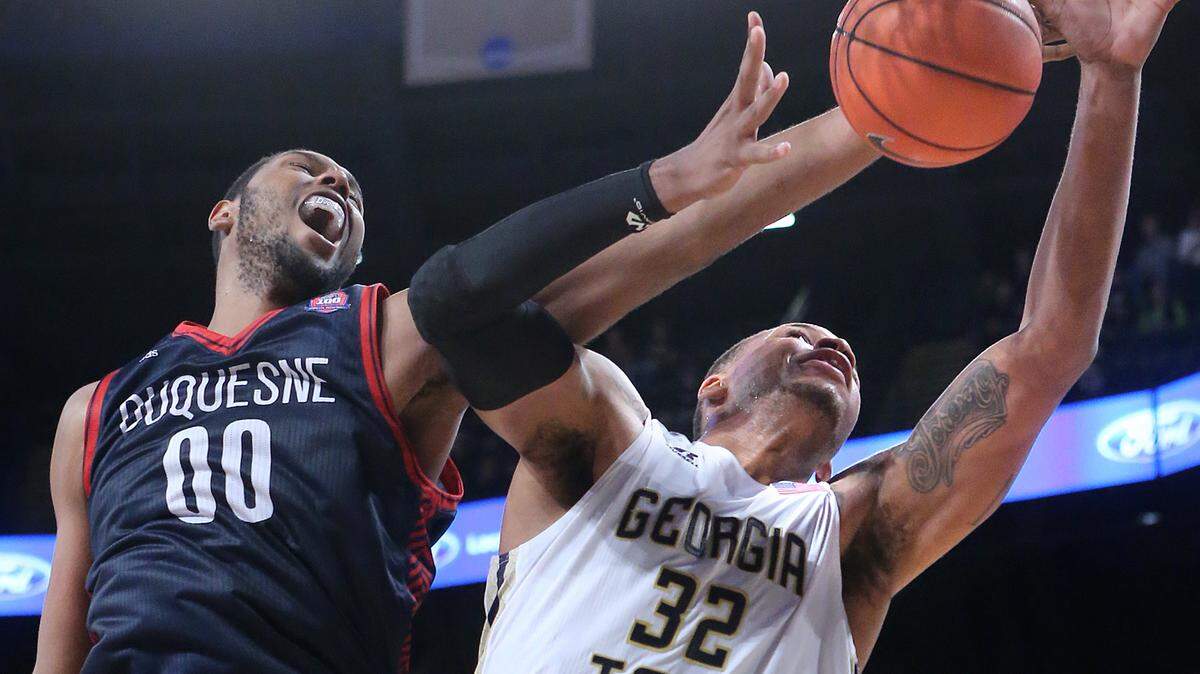 Duquesne center Darius Lewis blocks a shot by Georgia Tech forward Nick Jacobs during an NCAA college basketball game on Tuesday, Dec. 29, 2015, in Atlanta. (Curtis Compton/Atlanta Journal-Constitution via AP) MARIETTA DAILY OUT; GWINNETT DAILY POST OUT; LOCAL TELEVISION OUT; WXIA-TV OUT; WGCL-TV OUT; MANDATORY CREDIT