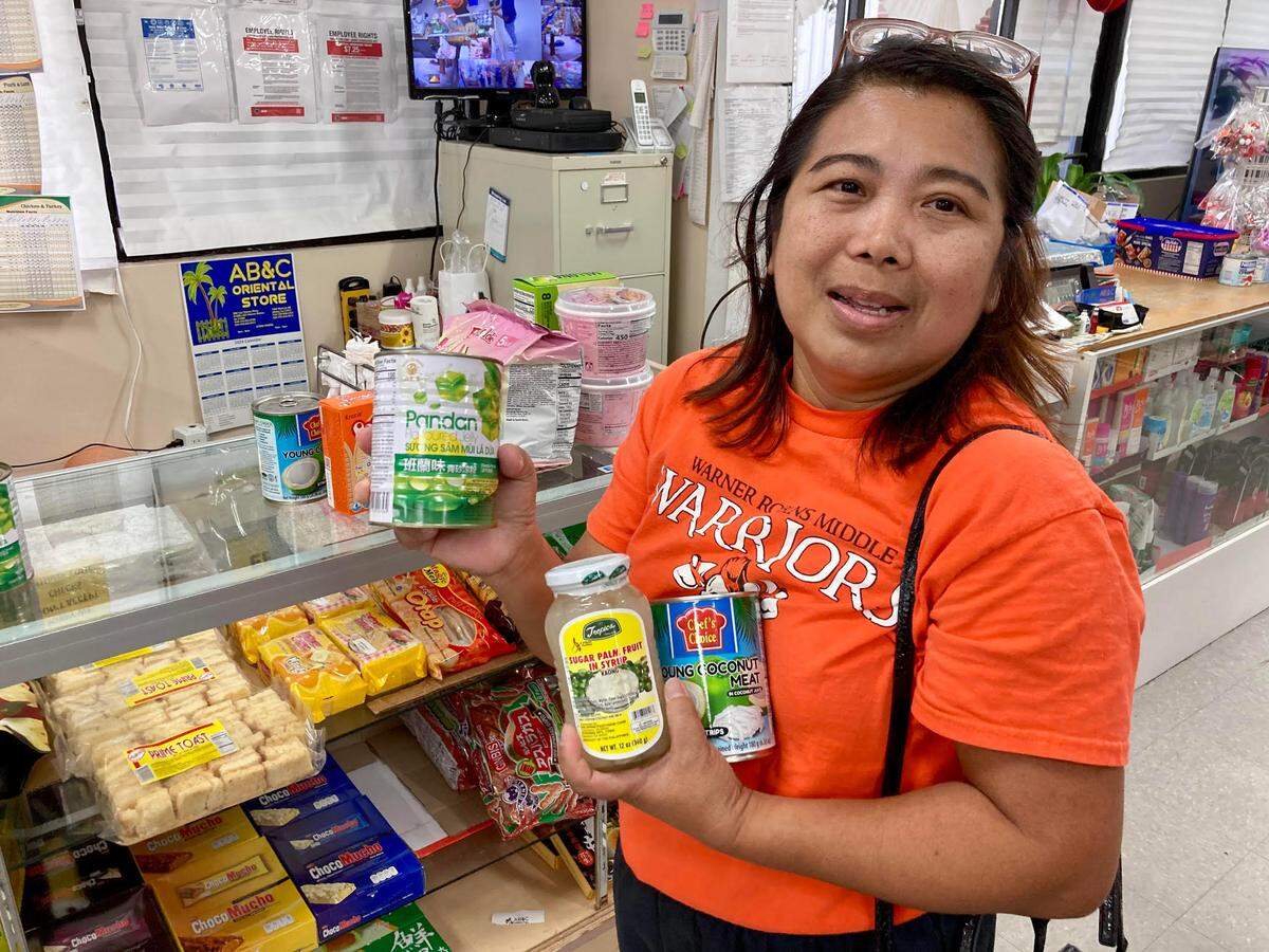Bliss Arnold talks about the ingredients needed to make Buko Pandan, a favorite Filipino dessert, while shopping at AB&C Oriental Store in Warner Robins.