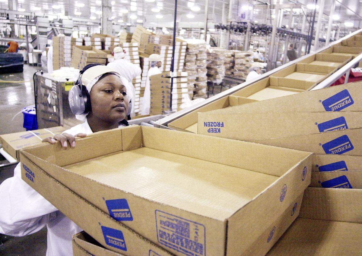 A worker stacks boxes at the Perdue Farms food plant in Perry in this Telegraph file photo.