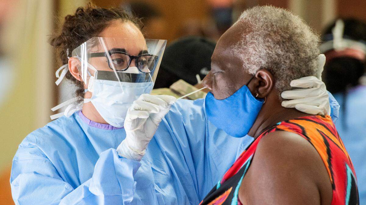 Sgt. Jessica Borg with the 148th Brigade Support Battalion performs a deep nasal swab COVID-19 test April 28 at Ebenezer Missionary Baptist Church.
