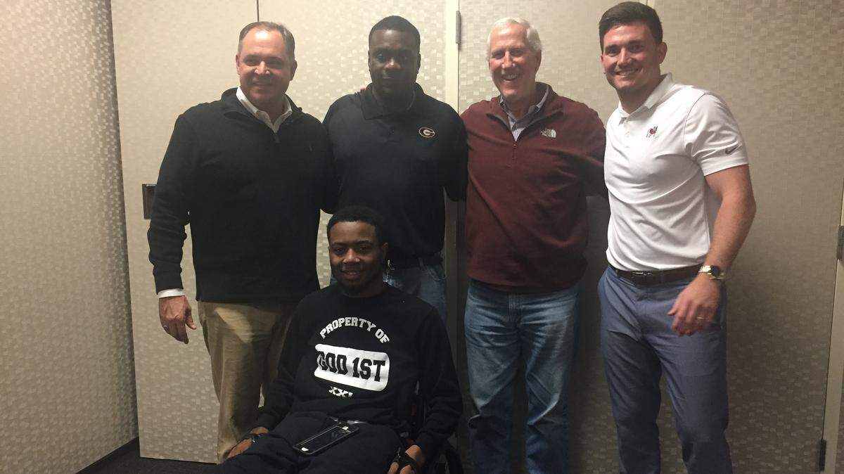 Devon Gales poses for a photo with (from left to right) Jim Butterworth, Bryant Gantt, Ray Goff and Marshall Morgan.
