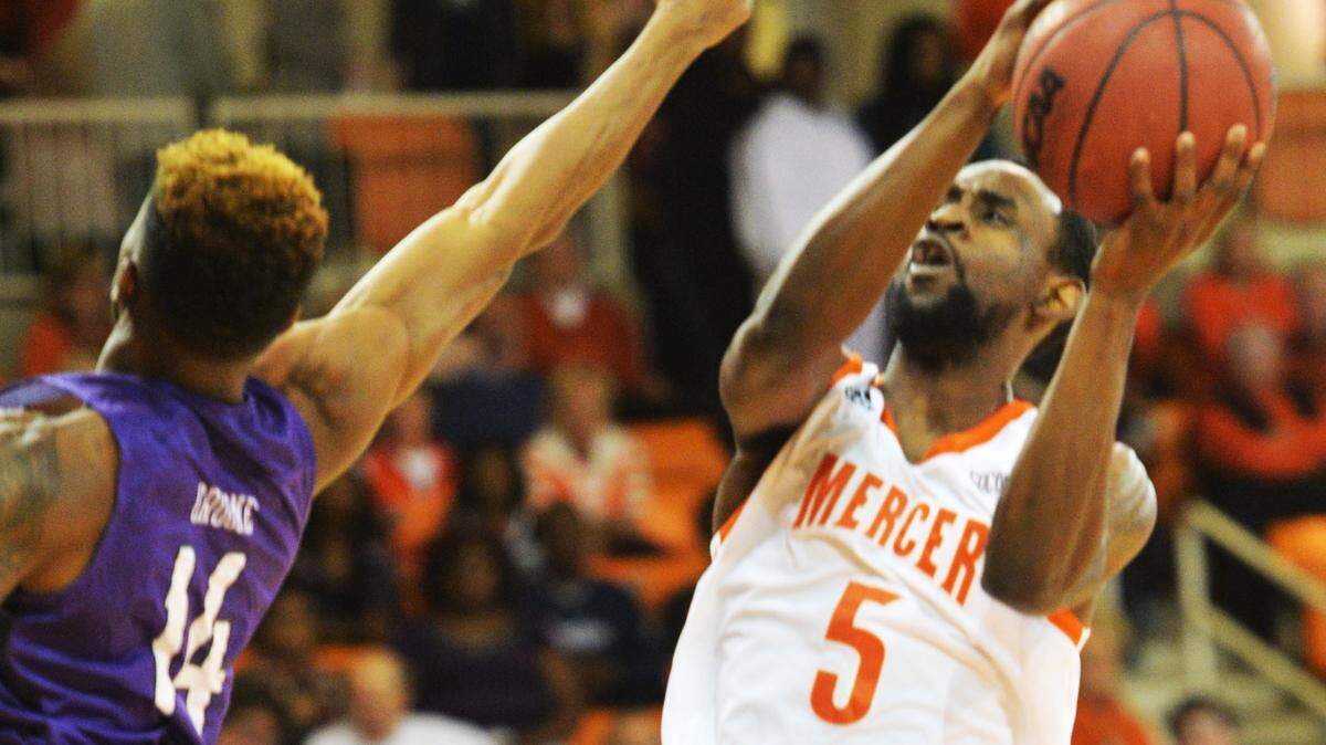 Mercer guard Jestin Lewis (5) drives by Furman for a first half bucket. Lewis scored 10-points during the half.