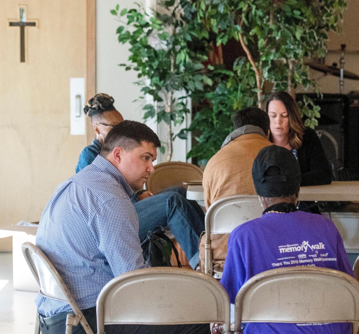 JASON VORHEES/THE TELEGRAPH Macon, GA, 01/28/2019: Brandon Miller, bottom left, chairman of the Houston County Human Needs Coalition speaks with a resident while helping with a homeless count at First United Methodist Church in Warner Robins Monday.