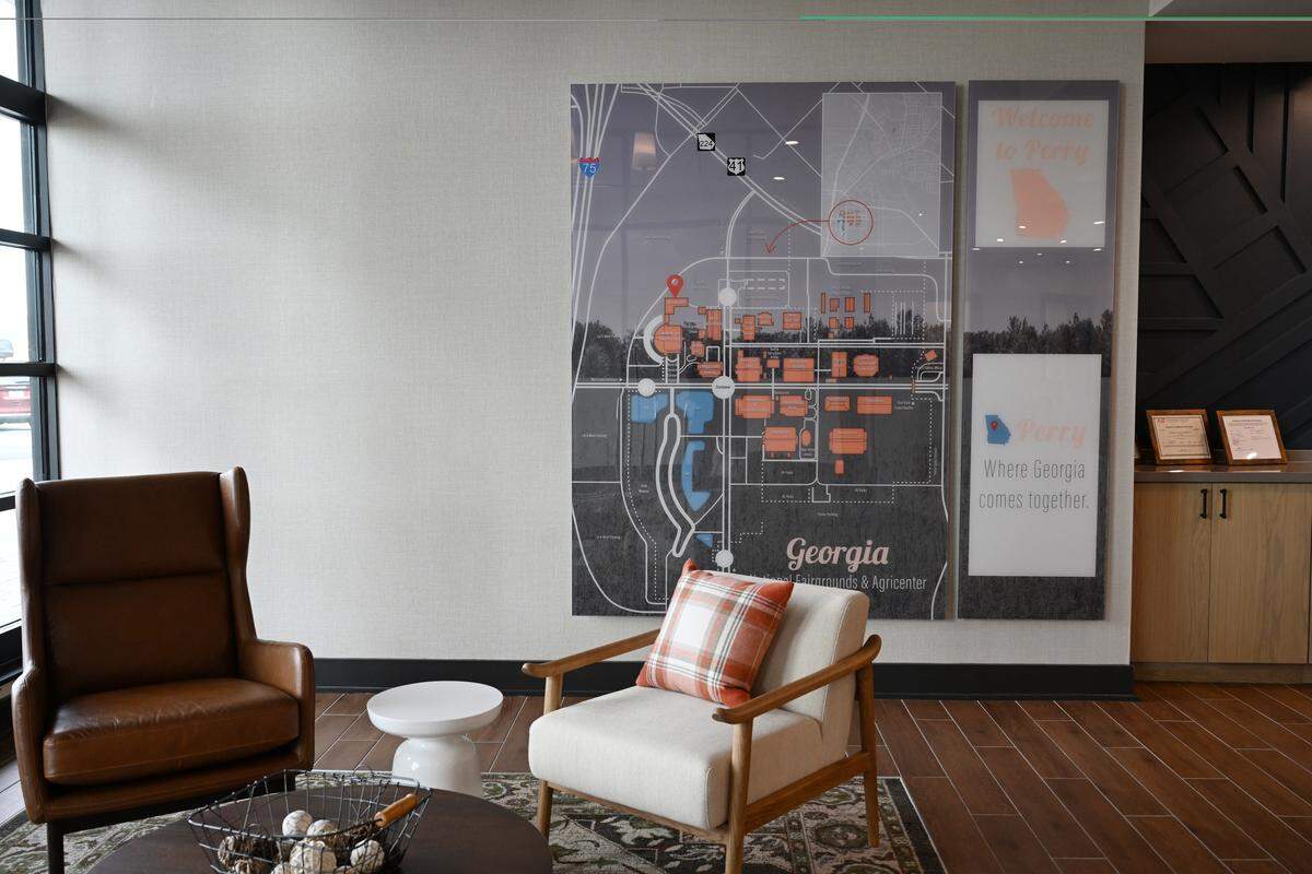 A seating area near the reception desk welcomes guests to the lobby, along with a map of the Georgia National Fairgrounds & Agricenter. The new Fairfield by Marriott Inn and Suites and TownePlace Suites by Marriott was built on the fairgrounds in Perry, Ga.