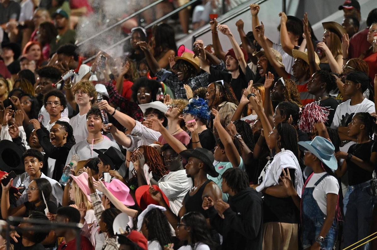 Game attendees in the Warner Robins student section cheer during the football game between Warner Robins and Northside High Schools on Friday, Aug. 30, 2024, at McConnell Talbert Stadium in Warner Robins, Georgia. The Warner Robins High School football team defeated the Northside High School team 34-12.