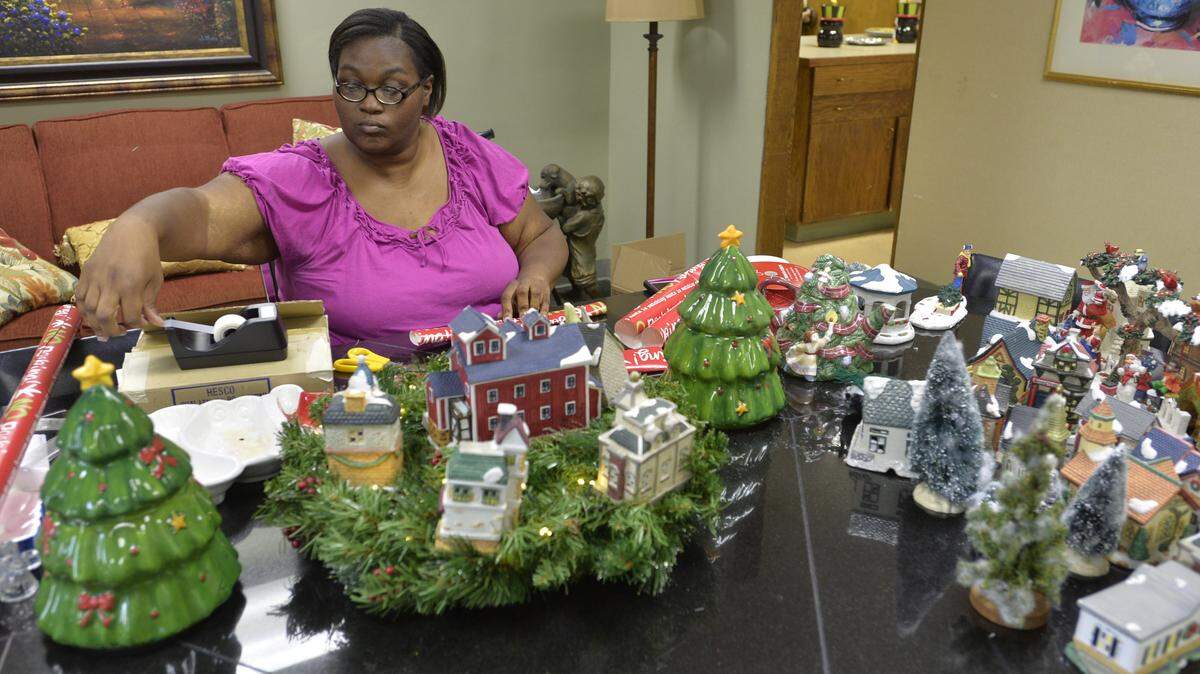 Debra Hughes wraps Christmas presents for the needy at the Mentors Project headquarters.