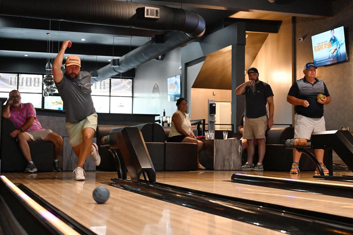 Trevor Stelson (left) bowls at the Social Duck on Friday, July 11, 2025, in downtown Macon, Georgia. Stelson scored a 212 and was the first person at The Social Duck so far to break a score of 200.