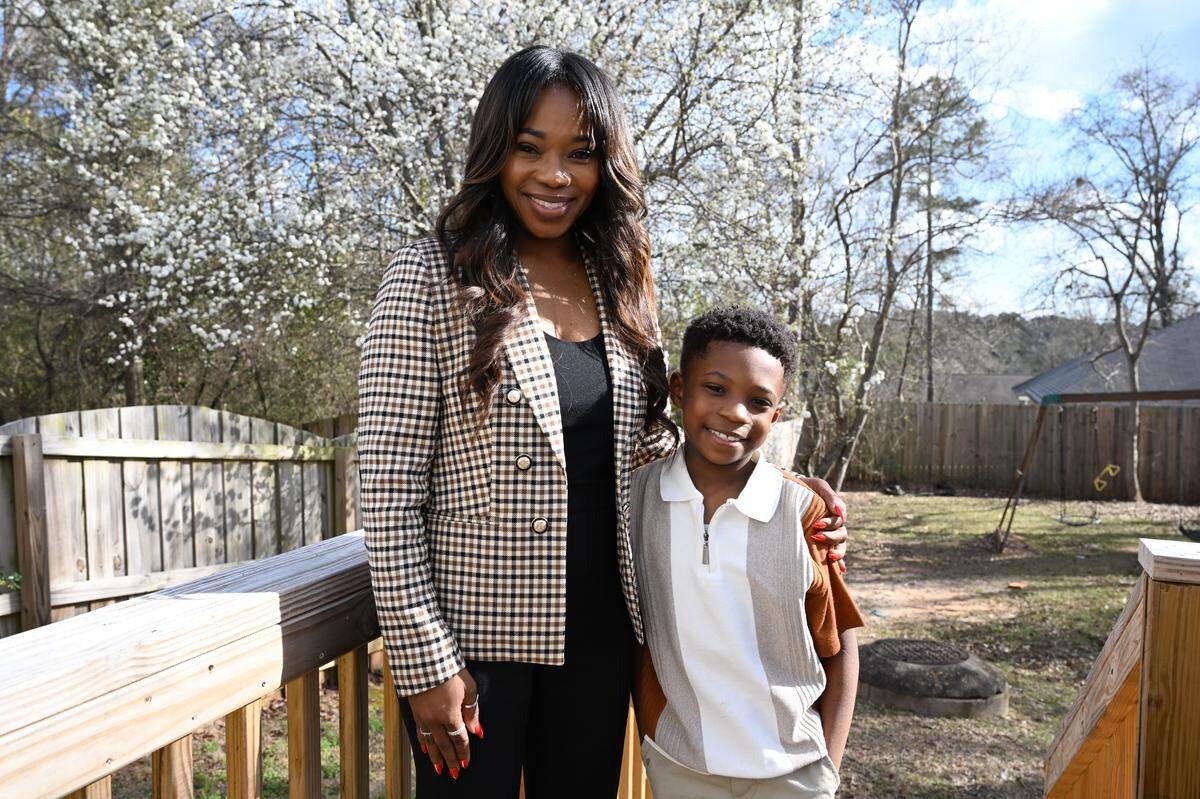 Warner Robins Mayor LaRhonda Patrick (left) poses with her son Laine, 8, on Thursday, March 5, 2026, in their backyard in Warner Robins, Georgia.