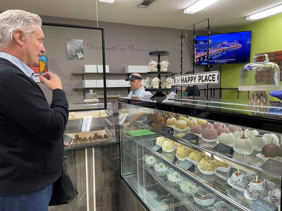 Al Chromy, principal of Sacred Heart Catholic School in Warner Robins, was the first customer at the reopening of The Apple Basket in Centerville on Monday, May 5, 2025. He bought 35 gourmet caramel apples for teacher appreciation day.