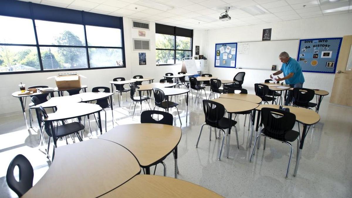 Cirrus Academy 8th grade Georgia Studies teacher decorates his room Friday morning. The new charter school is set to open its doors to students on Monday.