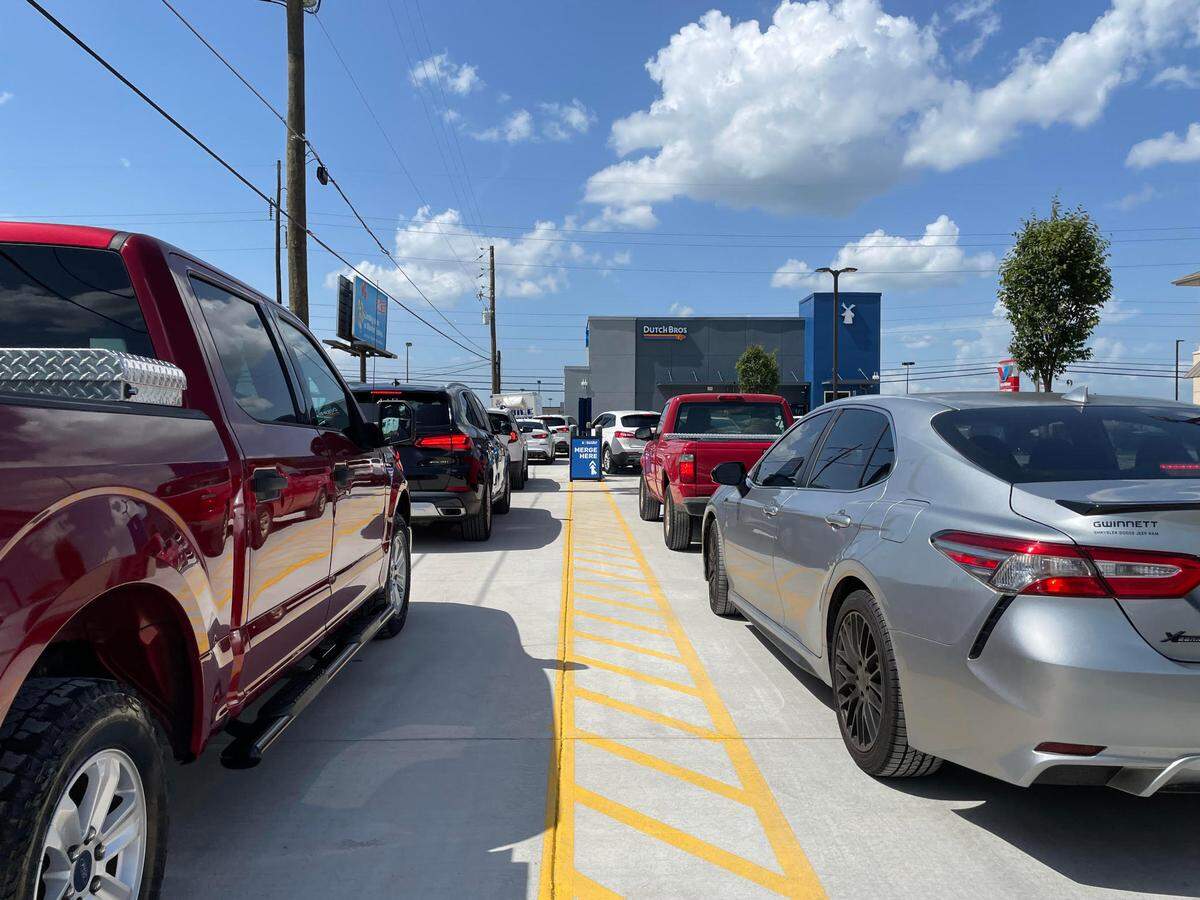 Vehicles line up at Georgia’s first Dutch Bros Coffee at 2695 Watson Blvd. in Warner Robins on opening day late Sunday afternoon, July 13, 2025.