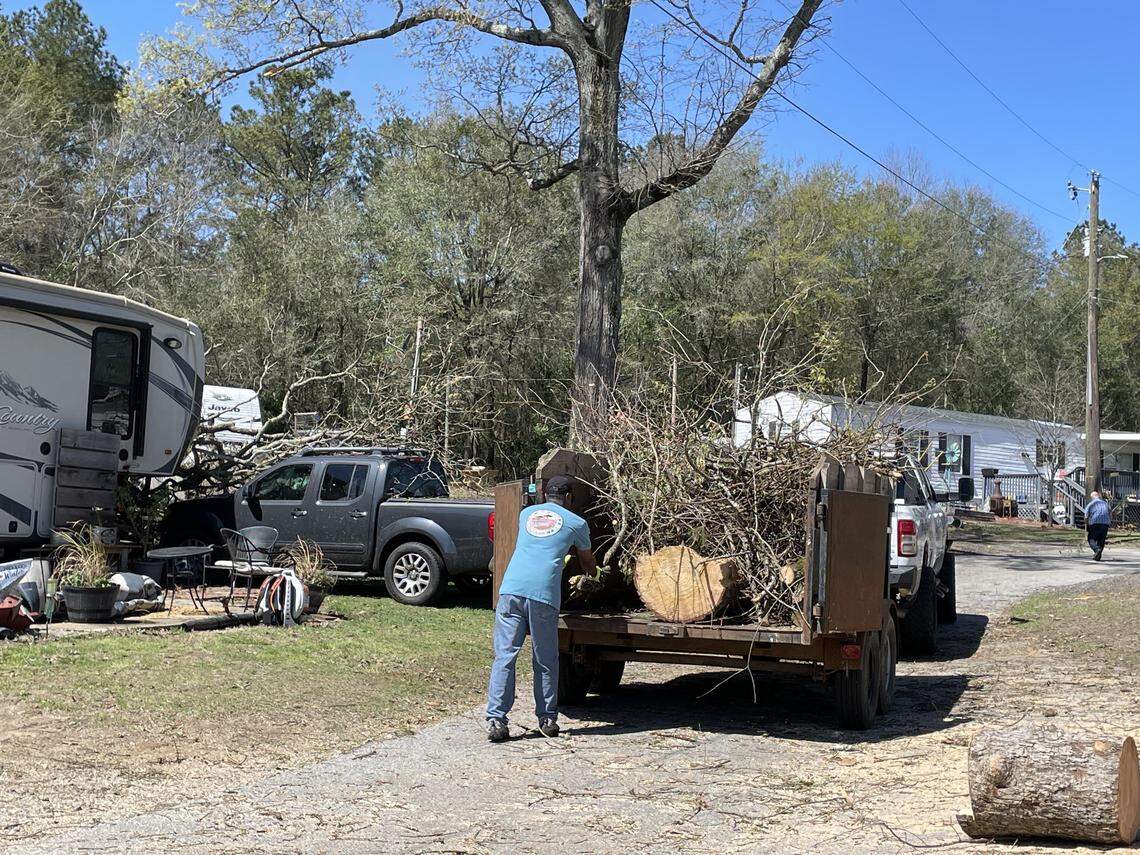 A man loads storm debris into a trailer bed at the Ponderosa RV Park off Ga. 96 in Peach County on Thursday afternoon, March 12, 2026.