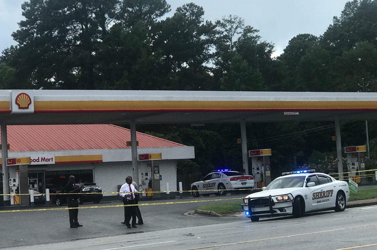 Investigators get to work at this Shell gas station at Mercer University and Atwood drives where Randon Shamar Hogan was shot July 10, 2019.