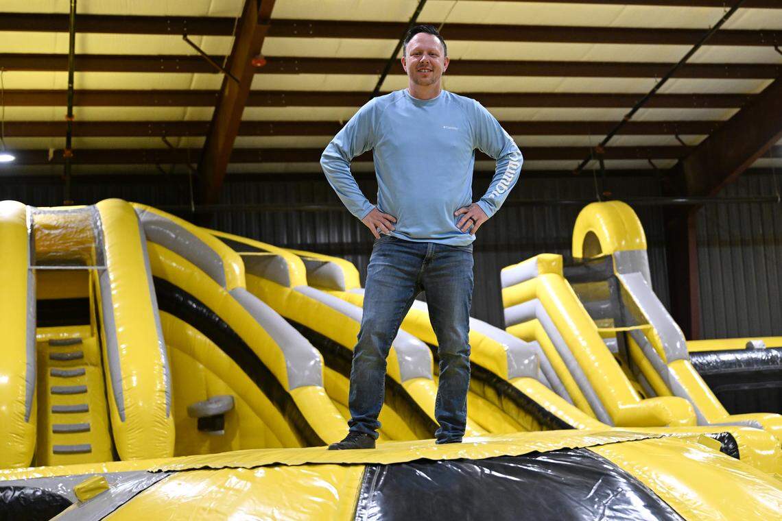 Co-owner Todd Buckelew poses on top of the “King of the Hill” attraction inside of the inflatable of the new Xtreme Air Mega Park in Warner Robins. This is the third trampoline park for Buckelew and his brother, Brad.