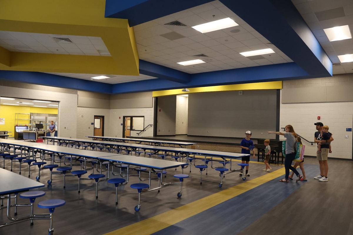 Springdale Elementary School students and families walk through the brand new cafeteria during open house on Friday, Aug. 2, 2024, in Macon, Georgia. The original Springdale Elementary opened 53 years ago, but this brand new building completed this summer will be ready for the new school year starting Aug. 5.