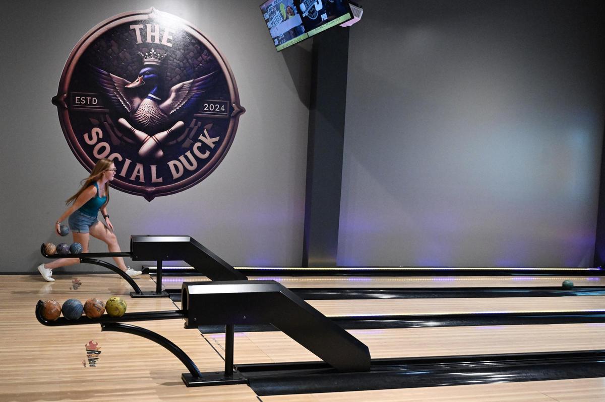 Kristen Hallett, from Macon, Georgia, bowls at the Social Duck for the first time on Friday, July 11, 2025, in downtown Macon, Georgia. The new duckpin bowling alley opened off of Second Street in early July.