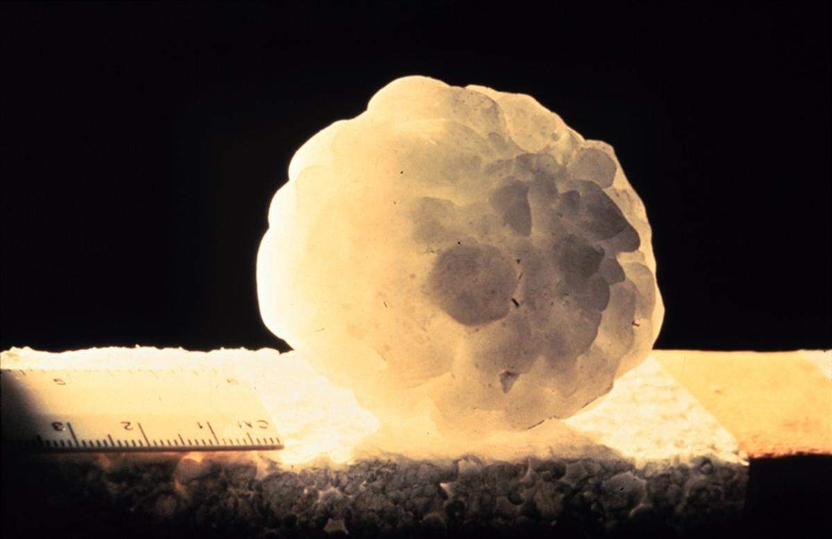 Aggregate hailstone. Large hailstone with smaller stones visible. Ruler shows radius of this remarkable hail stone. Diameter is approximately 6 centimeters - the size of a baseball.