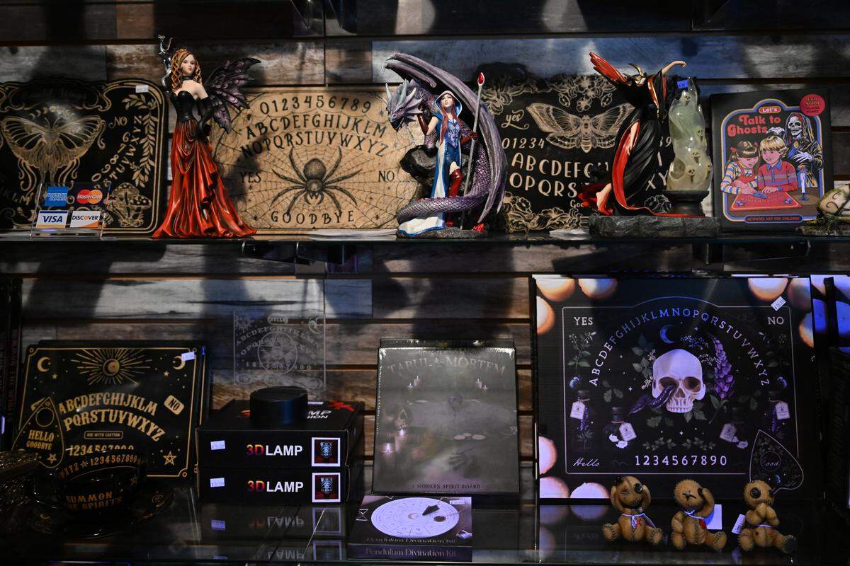 Figurines and spirit boards sit on a shelf inside The M Cave in Centerville. The fantasy gift shop carries a wide variety of merchandise honoring various religions, as well as other spiritual practices.