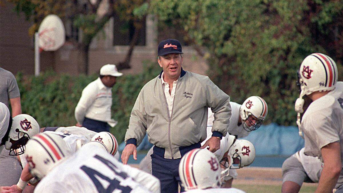 Auburn coach Pat Dye walks through his players as they begin workouts in preparation for the Sugar Bowl in New Orleans, Dec. 27, 1988. Dye will lead the Tigers against Florida State on January 2. (AP Photo/Bill Haber)