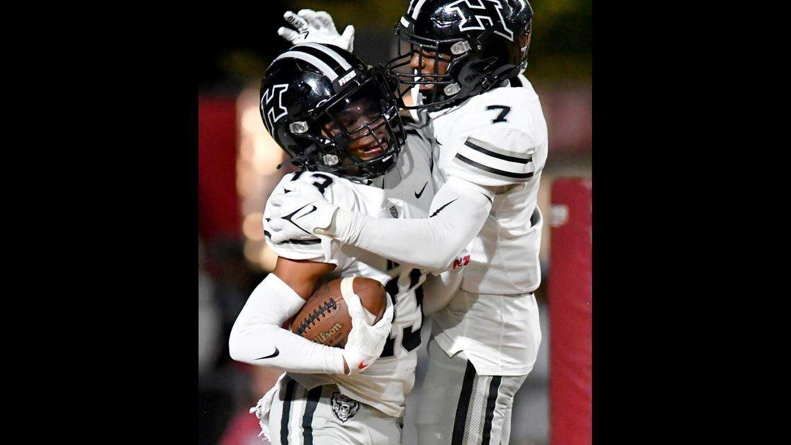 Houston County’s Darius Patterson (13) is congratulated by teammate JD Smith (7) after returning an interception for a touhdown during the Bears’ 45-38 win over Perry.