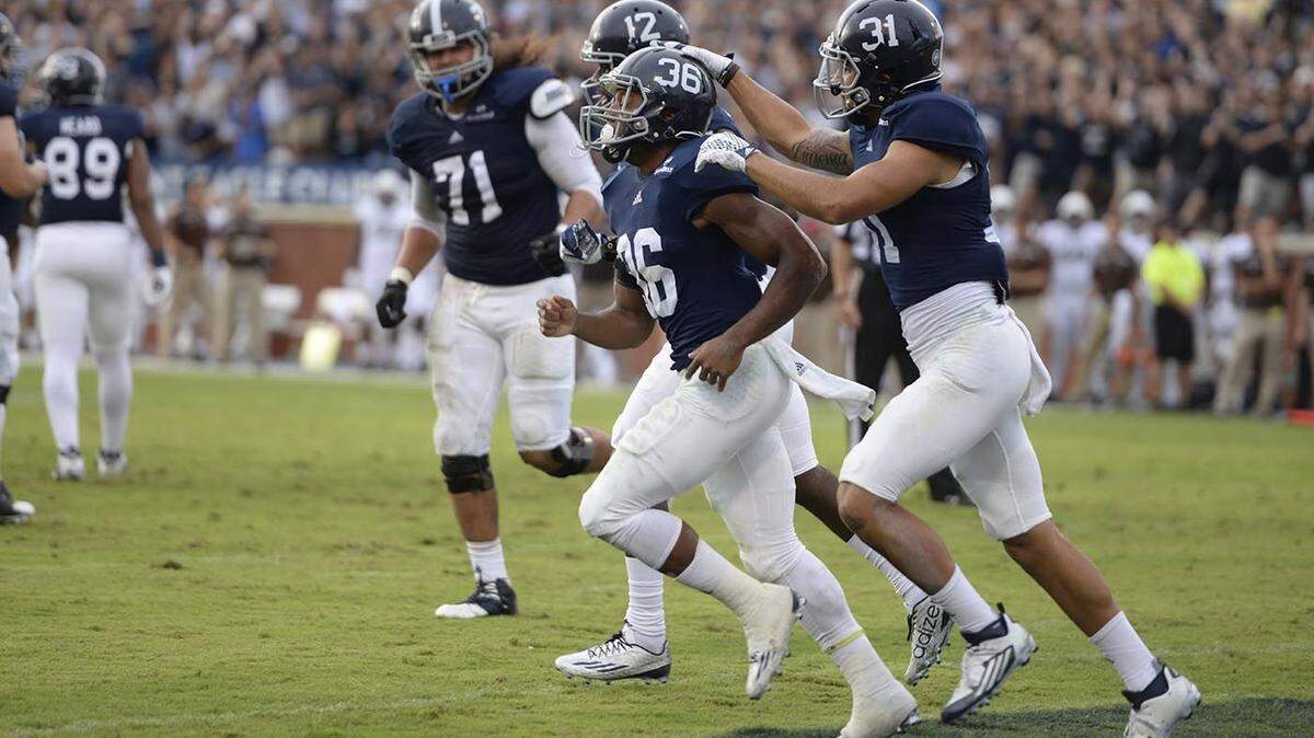 Georgia Southern running back Matt Breida celebrates with wide receiver Ryan Longoria and other teammates after a touchdown against Western Michigan on Sept. 12.