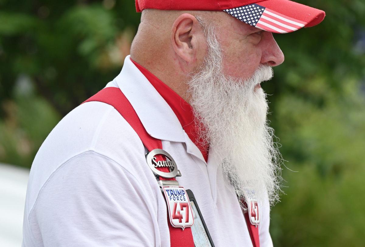 Montana Martin Jones, who follows the Trump Vance bus tour as “Trump Santa,” talks to attendees on Friday, Oct. 4, 2024, outside of the Bibb County GOP office in Macon, Georgia. The Trump Vance presidential campaign made a stop in Macon on a bus tour across Georgia beginning on Friday and traveling throughout the weekend with local and national Republican representatives.
