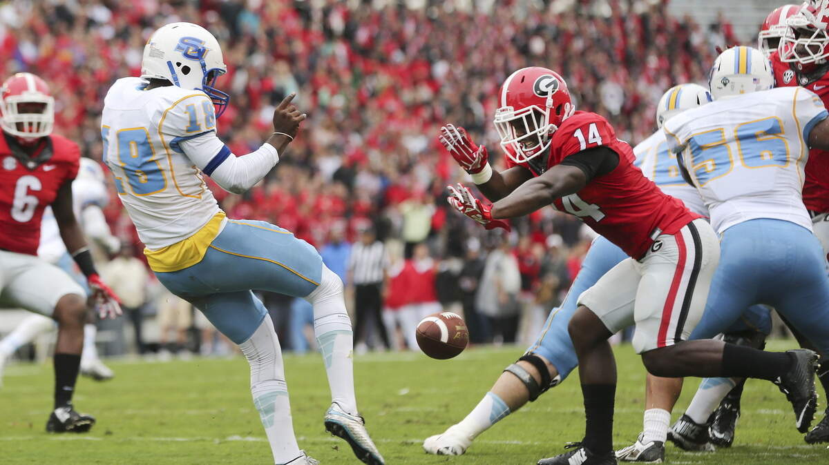 Southern punter Greg Pittman has his punt blocked by Georgia’s Malkom Parrish (14) during the first half Saturday in Athens.