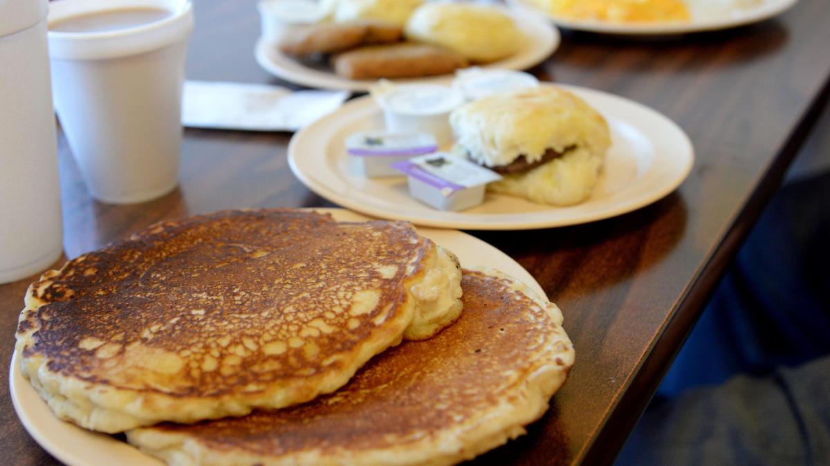 JENNA EASON/THE TELEGRAPH Macon, GA, 12/23/2019: Pancakes and a sausage biscuit at Johnny V’s in Macon.