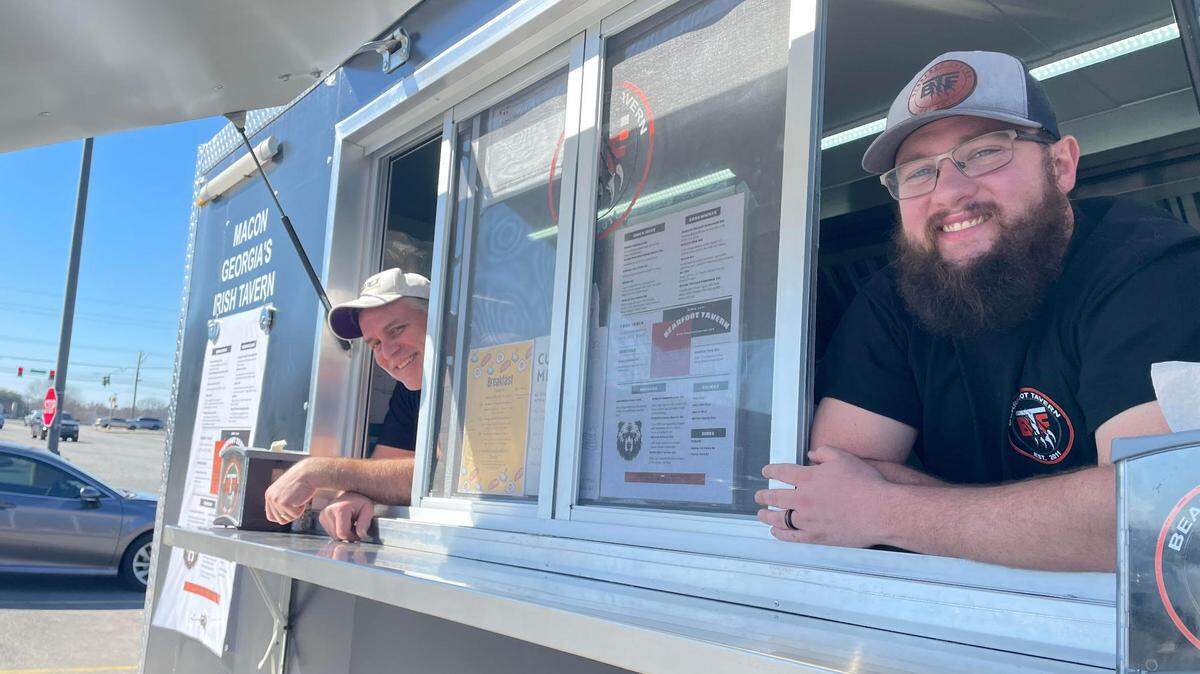 Mark Bell, right, general manager of the Bearfoot Tavern in downtown Macon, and Scott Heck, the gastropub’s kitchen manager, are set up in the food truck Wednesday, Feb. 26, 2025, in the Lowe’s Home Improvement parking lot off Watson Boulevard.