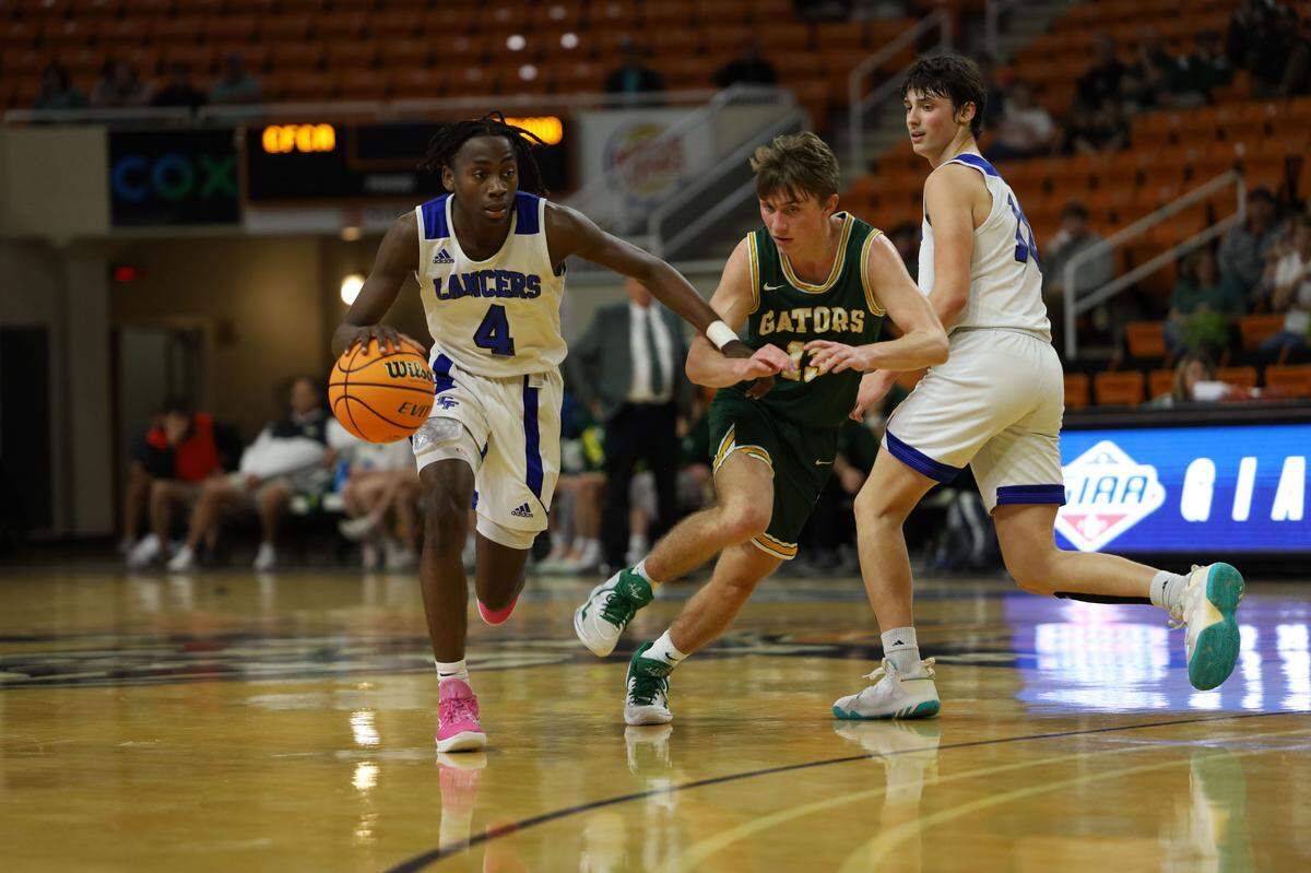 Central Fellowship’s Karez Demory (4) dribbles off of teammate’s Tanyon Stella’s screen on Gatewood’s Kaden Keiser during the second half of the GIAA Final Four at Hawkins Arena in Macon. CFCA defeated Gatewood to advance to the championship.