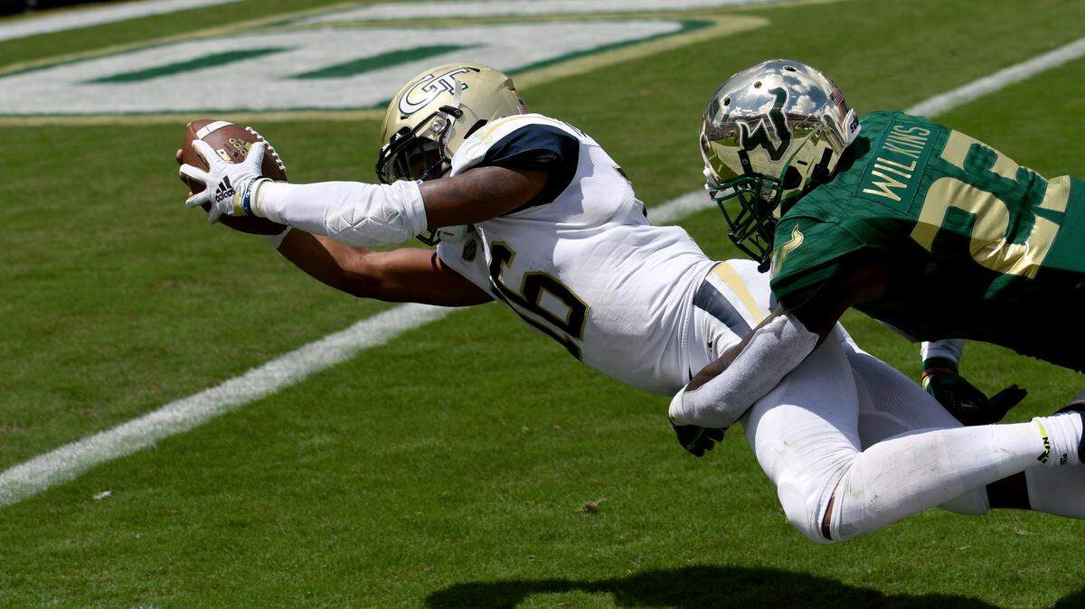 South Florida cornerback Mazzi Wilkins (23) can’t stop Georgia Tech quarterback TaQuon Marshall (16) as he dives into the end zone for a touchdown during the first quarter of an NCAA football game Saturday, Sept. 8, 2018, in Tampa, Fla. (AP Photo/Jason Behnken)