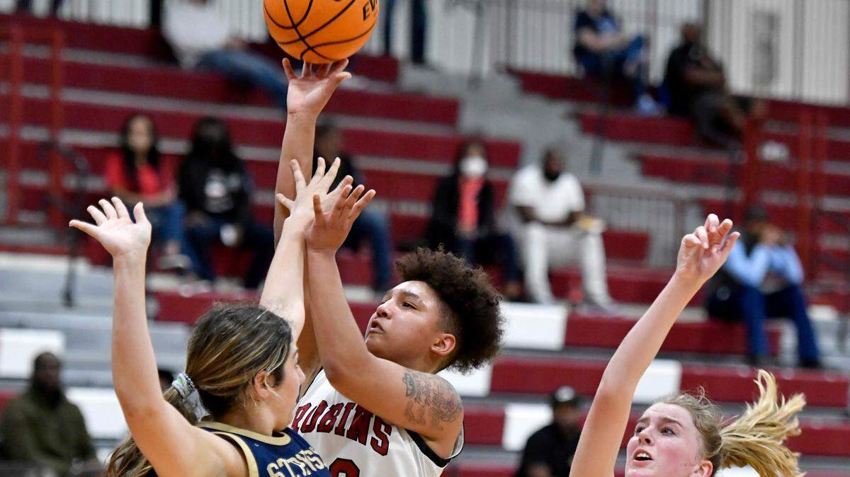 Warner Robins’ Jada Morgan (30) puts up a shot over St. Pius X defenders during the Demonettes’ 63-48 win in their second round state playoff game. Morgan is one of the Telegraph’s finalists for girls player of the year.