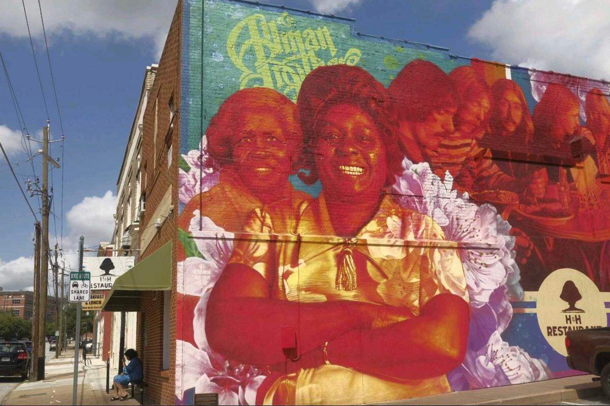Artist Steven Teller’s mural of H&H restaurant founders Inez Hill and Louise Hudson with their famous Allman Brothers Band patrons has become an attraction for the band’s fans. The Macon Arts Alliance that is working to bring more murals to downtown.