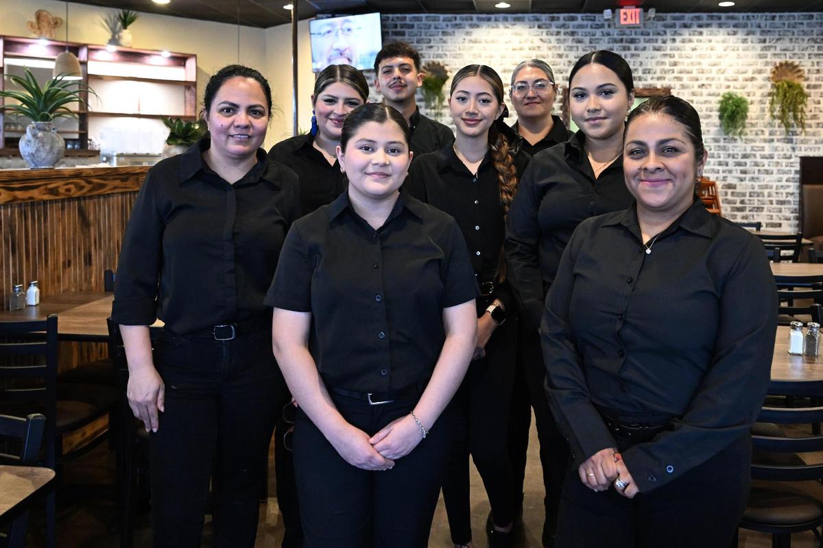 Close friends and business partners Alma Valencia (far left) and Jazmin Esparza-Ortiz (far right) pose with employees inside at Cozumel Mexican Grill before the restaurant’s opening late Wednesday afternoon, April 23, 2025, in Perry.